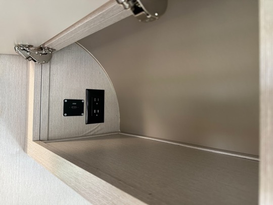 Power and HDMI plugs in overhead storage
